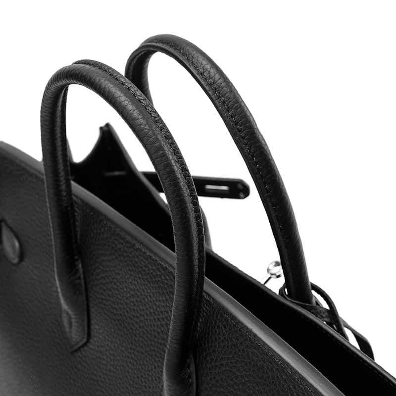 Stylish black leather handbag featuring dual handles and a sleek design, ideal for daily use and fashion-forward individuals.